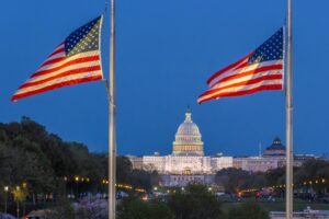 Dramatic evening view of the U.S. Capitol with American flags in Washington, D.C.